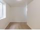 A carpeted basement room features two windows and bright walls perfect for flexible usage at 1945 Nome St, Aurora, CO 80010