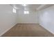 A carpeted basement room features neutral walls and a window to provide natural light at 1945 Nome St, Aurora, CO 80010
