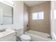 Updated bathroom featuring tile surround, a shower-tub combo, and a sleek vanity at 1945 Nome St, Aurora, CO 80010