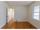 Bright bedroom features hardwood floors and neutral walls with an inviting hallway view at 1945 Nome St, Aurora, CO 80010