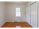 Simple bedroom with hardwood floors, white walls, and a closet for ample storage at 1945 Nome St, Aurora, CO 80010
