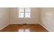 Bedroom with hardwood floors, neutral walls, and a bright window at 1945 Nome St, Aurora, CO 80010