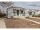 A charming single-story home with a walkway leading to the front door, complemented by minimal landscaping at 1945 Nome St, Aurora, CO 80010