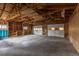 The spacious garage has high ceilings, wooden framework, and two garage doors at 1945 Nome St, Aurora, CO 80010