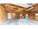 The large garage offers ample storage space with wooden framing and shelving at 1945 Nome St, Aurora, CO 80010