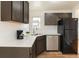 Updated kitchen features stainless appliances, modern countertops, and neutral finishes at 1945 Nome St, Aurora, CO 80010