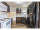Updated kitchen boasts stainless appliances, white subway tile backsplash, and modern cabinetry at 1945 Nome St, Aurora, CO 80010