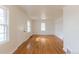 Open living room with newly refinished hardwood floors and multiple windows, providing great natural light at 1945 Nome St, Aurora, CO 80010