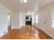 Spacious living room showcasing hardwood floors, fresh paint, and an open layout flowing into the kitchen at 1945 Nome St, Aurora, CO 80010