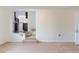 The living room features neutral carpet, white walls, and stairs leading to a glimpse of the kitchen at 1945 Nome St, Aurora, CO 80010