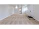 The living room features neutral carpet, white walls, and a door leading to another room at 1945 Nome St, Aurora, CO 80010