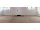 The living room features neutral carpet, white walls, and two windows providing natural light at 1945 Nome St, Aurora, CO 80010