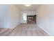 Spacious living room features brick fireplace and neutral carpet, offering a warm atmosphere at 1945 Nome St, Aurora, CO 80010