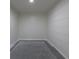 The storage room features planked white walls and gray concrete flooring at 1945 Nome St, Aurora, CO 80010