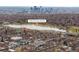 Aerial view of neighborhood by Rocky Mountain Lake Park, with a view of downtown Denver in the distance at 4824 Knox Ct, Denver, CO 80221