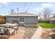 Cozy backyard with a stone patio, garden bed, and ample space for outdoor seating and relaxation at 4824 Knox Ct, Denver, CO 80221