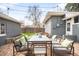 Backyard with a concrete patio featuring outdoor seating and a vibrant garden at 4824 Knox Ct, Denver, CO 80221