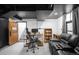 Finished basement with a dark ceiling, living area, and workspace at 4824 Knox Ct, Denver, CO 80221