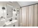 Bathroom with a modern vanity, decorative sconces, and a shower with a curtain at 4824 Knox Ct, Denver, CO 80221