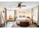 Spacious primary bedroom featuring a ceiling fan, natural light, a sitting chair and hardwood floors at 4824 Knox Ct, Denver, CO 80221