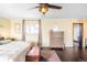 Comfortable primary bedroom featuring a ceiling fan, natural light, and a traditional style dresser at 4824 Knox Ct, Denver, CO 80221