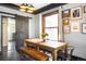 Dining area featuring an attractive wooden dining table set and a sliding barn door at 4824 Knox Ct, Denver, CO 80221