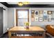 Dining area featuring an attractive wooden dining table set and a sliding barn door at 4824 Knox Ct, Denver, CO 80221