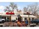 Charming exterior of Bill's Inn featuring outdoor seating area with picnic tables at 4824 Knox Ct, Denver, CO 80221
