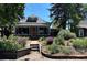 Charming home with a lush front yard and colorful, landscaped garden beds adding curb appeal at 4824 Knox Ct, Denver, CO 80221
