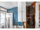 Hallway to a laundry room area featuring a modern, stacked washer and dryer at 4824 Knox Ct, Denver, CO 80221