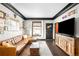 Bright living room features a leather sofa, hardwood floors, and large windows at 4824 Knox Ct, Denver, CO 80221