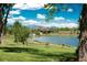 Picturesque park view featuring a serene lake and walking paths with mountain views at 4824 Knox Ct, Denver, CO 80221