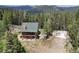 Mountain cabin aerial view showing large lot in wooded area at 1555 Three Peaks Rd, Golden, CO 80403