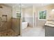 Luxurious bathroom featuring a glass-enclosed shower, a standalone soaking tub, and scenic forest views at 1555 Three Peaks Rd, Golden, CO 80403