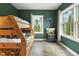 Charming bedroom with a bunk bed, and a window offering scenic views of the surrounding woodlands at 1555 Three Peaks Rd, Golden, CO 80403