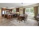 Well-lit kitchen and dining area with wood floors, an island with seating, and large windows at 1555 Three Peaks Rd, Golden, CO 80403