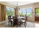 Bright dining room with wood floors, chandelier, and large windows, offering a delightful space for meals at 1555 Three Peaks Rd, Golden, CO 80403