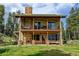 Charming home with a stone chimney, covered patio, and a balcony perfect for enjoying the outdoors at 1555 Three Peaks Rd, Golden, CO 80403