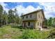 View of the home's exterior and the yard at 1555 Three Peaks Rd, Golden, CO 80403