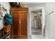 A hallway with a utility closet and an entryway with a shelf for storage at 1555 Three Peaks Rd, Golden, CO 80403