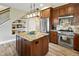 Well-equipped kitchen with stainless steel appliances, granite island, and a gas range at 1555 Three Peaks Rd, Golden, CO 80403
