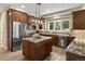 Gorgeous kitchen featuring custom wood cabinets, granite countertops, stainless steel appliances, and center island at 1555 Three Peaks Rd, Golden, CO 80403
