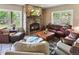 Comfortable living room with a stone fireplace, hardwood floors, and ample seating for relaxation and entertainment at 1555 Three Peaks Rd, Golden, CO 80403