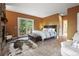 Bright and airy main bedroom with a balcony, stone fireplace, and a luxurious bed at 1555 Three Peaks Rd, Golden, CO 80403