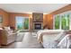 Spacious main bedroom featuring a stone fireplace, balcony access, and breathtaking views of the lake at 1555 Three Peaks Rd, Golden, CO 80403