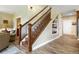 An elegant staircase with hardwood steps, rod iron spindles, and integrated shelves for decor at 1555 Three Peaks Rd, Golden, CO 80403