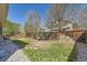 Large backyard featuring a wood fence and green grass and gravel, perfect for outdoor enjoyment at 24763 E Crestridge Pl, Aurora, CO 80016