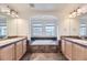Primary bathroom with double sinks, soaking tub, and tiled floors at 24763 E Crestridge Pl, Aurora, CO 80016