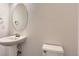 Powder room features a pedestal sink and oval mirror at 24763 E Crestridge Pl, Aurora, CO 80016
