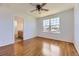 Bedroom with light wood floors, ceiling fan, and door to bathroom at 24763 E Crestridge Pl, Aurora, CO 80016